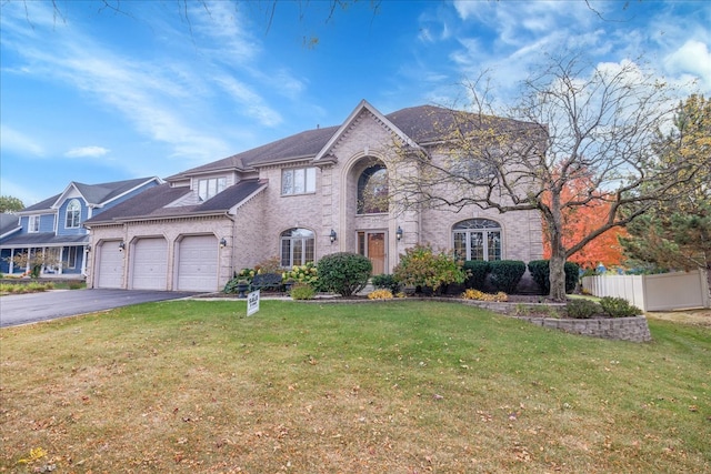 view of front of property with a front lawn and a garage