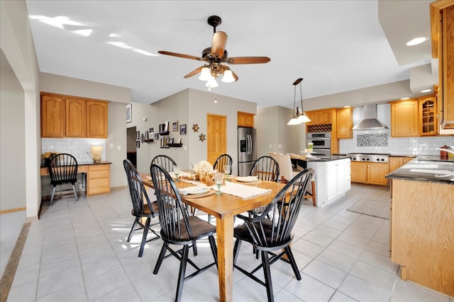 dining area with built in desk, sink, ceiling fan, and light tile patterned floors