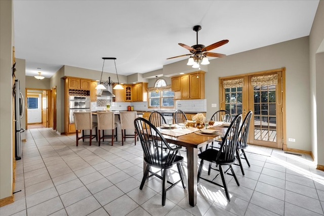 tiled dining room with french doors and ceiling fan