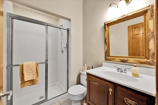 bathroom featuring vanity, tile patterned floors, toilet, and an enclosed shower