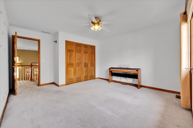 unfurnished bedroom featuring a closet, ceiling fan, and carpet flooring