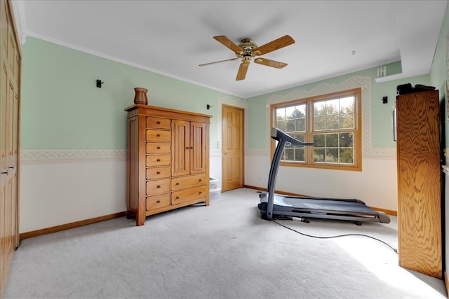 workout room with light carpet, crown molding, and ceiling fan