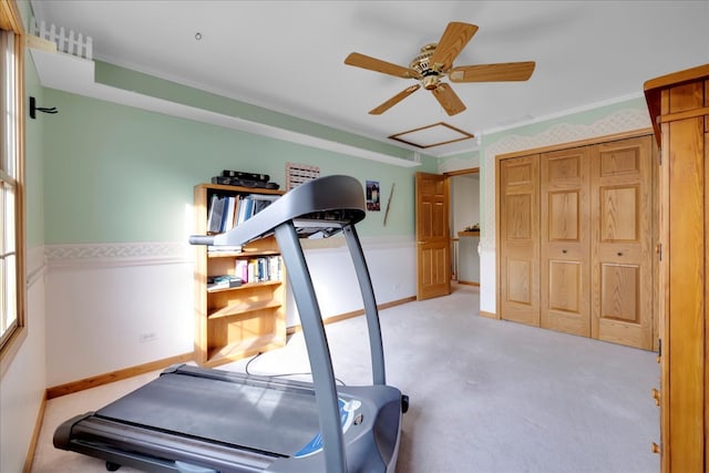 workout area featuring ceiling fan and light colored carpet