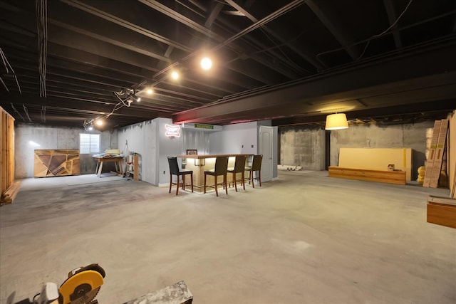 basement featuring indoor bar