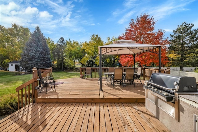 deck with a gazebo, a yard, and area for grilling