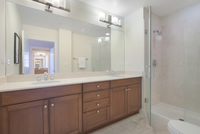 bathroom featuring vanity, a shower with shower door, toilet, and tile patterned flooring