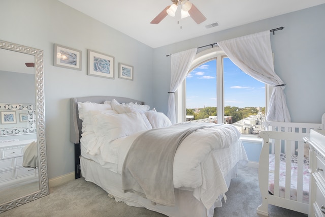 bedroom featuring light carpet and ceiling fan