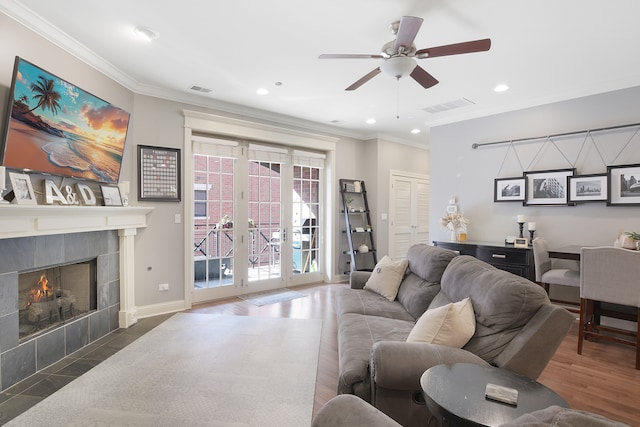 living room with ornamental molding, dark hardwood / wood-style floors, and ceiling fan