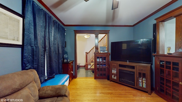 living room with light hardwood / wood-style floors and ornamental molding