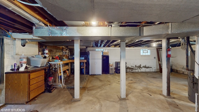 basement with white refrigerator