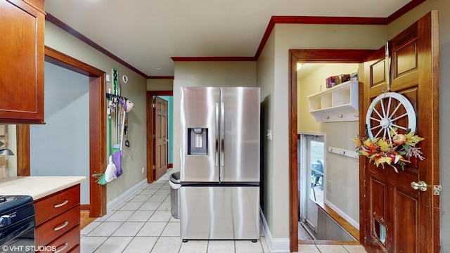 kitchen featuring stainless steel fridge, crown molding, light tile patterned floors, and black range