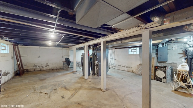 basement with heating unit, electric panel, a wealth of natural light, and water heater