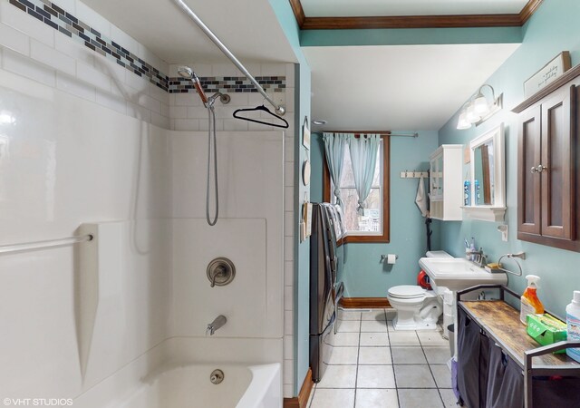 full bathroom with tile patterned floors, tiled shower / bath combo, toilet, and ornamental molding