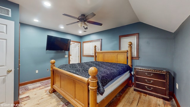 bedroom with hardwood / wood-style flooring, ceiling fan, and vaulted ceiling