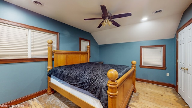 bedroom featuring light hardwood / wood-style floors, a closet, lofted ceiling, and ceiling fan