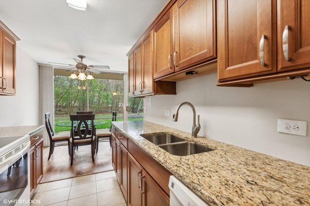 kitchen featuring white electric range, sink, light tile patterned floors, ceiling fan, and light stone counters