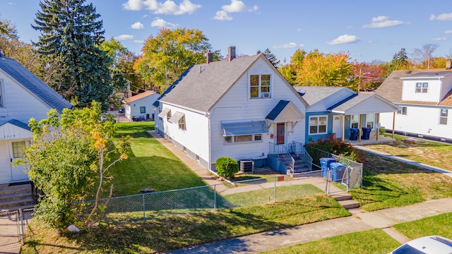 view of front facade with a front yard and central AC unit