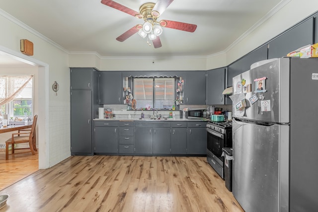 kitchen with gray cabinets, sink, stainless steel appliances, and light hardwood / wood-style floors