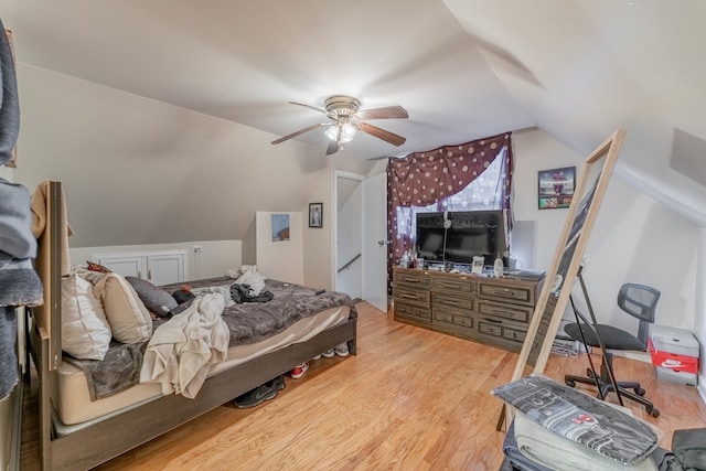 bedroom featuring ceiling fan, lofted ceiling, and light wood-type flooring