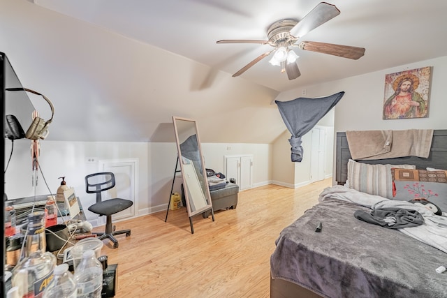 bedroom with vaulted ceiling, light hardwood / wood-style flooring, and ceiling fan