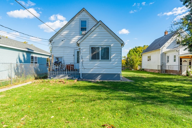 back of property with a lawn