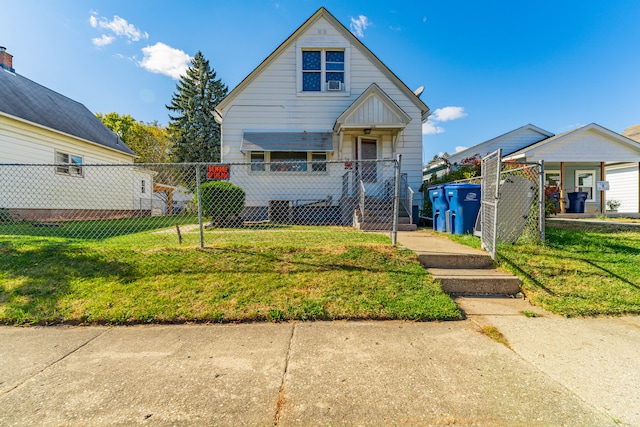 bungalow-style house featuring a front yard