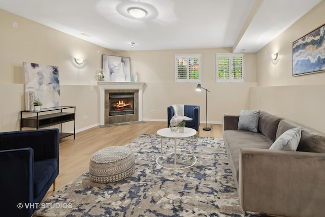 living room featuring light hardwood / wood-style flooring and a tile fireplace