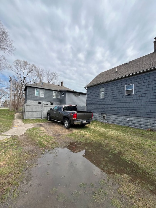 view of property exterior with a lawn