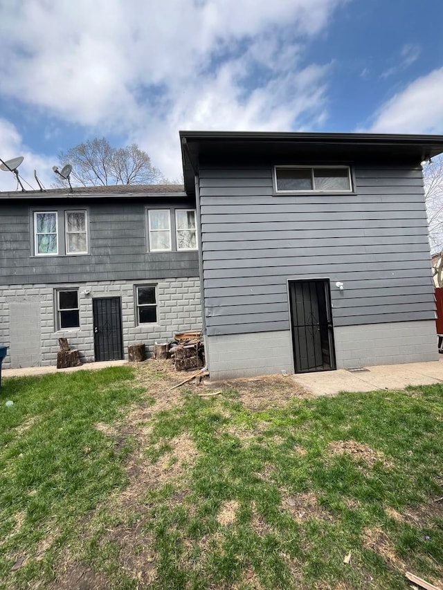 rear view of house with a yard