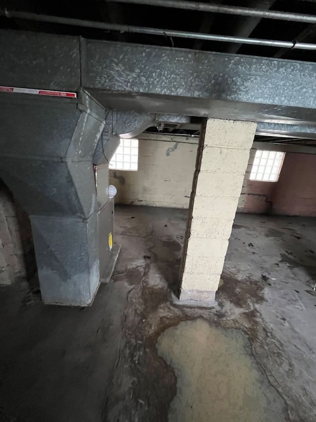 basement with a wealth of natural light and heating unit