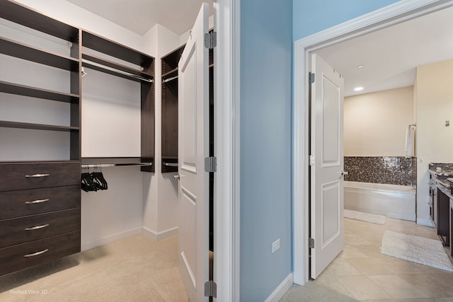 spacious closet featuring light tile patterned floors