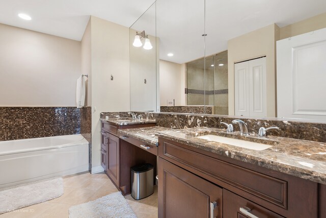 bathroom featuring vanity, shower with separate bathtub, and tile patterned floors