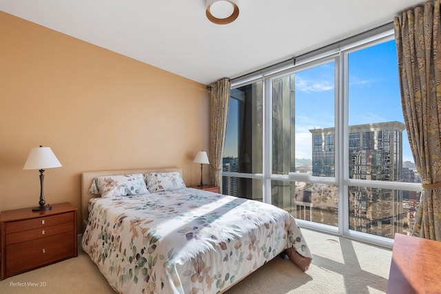 bedroom with light carpet and floor to ceiling windows