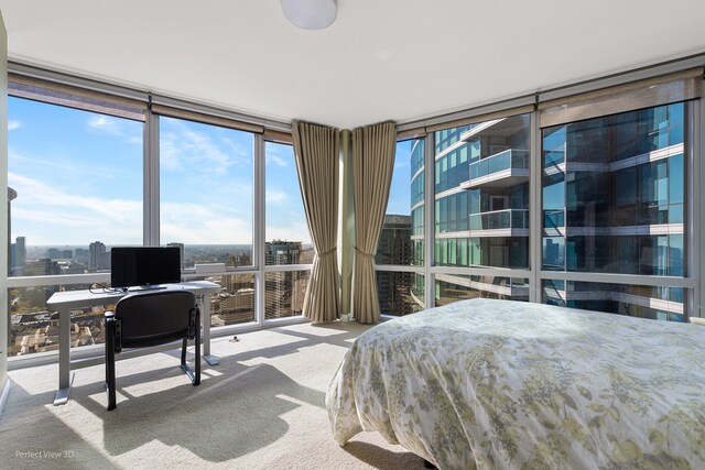 bedroom featuring a wall of windows and carpet floors