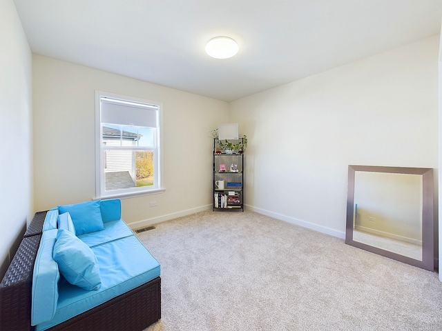 living area with light colored carpet