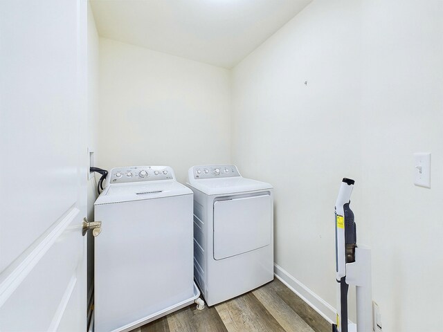 laundry area featuring independent washer and dryer and hardwood / wood-style flooring