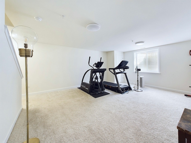 exercise area featuring light colored carpet