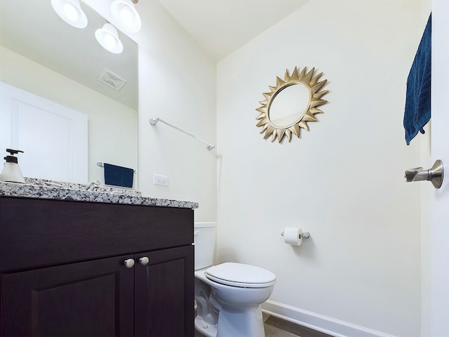 bathroom featuring vanity and toilet