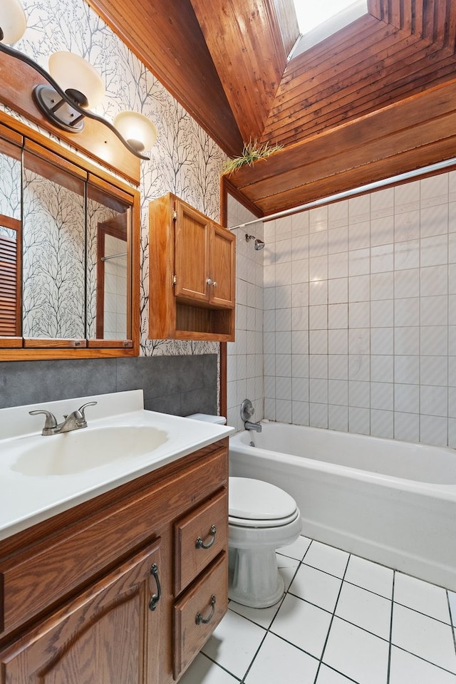 full bathroom featuring vanity, toilet, tiled shower / bath combo, and tile patterned flooring