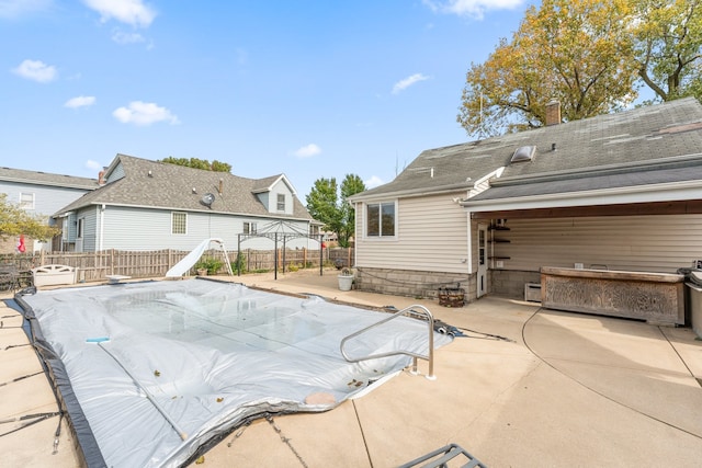 view of pool with a patio area and a water slide