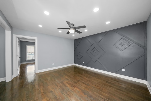 unfurnished room with dark hardwood / wood-style floors and ceiling fan