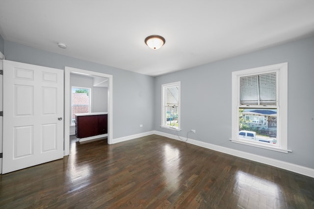 unfurnished room featuring dark wood-type flooring