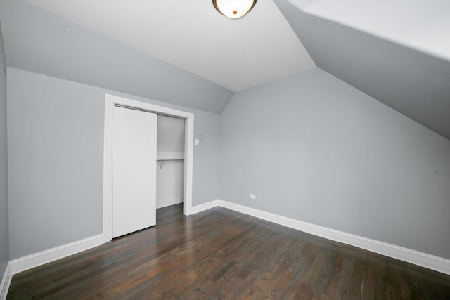 bonus room with lofted ceiling and dark hardwood / wood-style floors