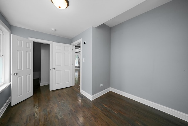 unfurnished bedroom featuring dark wood-type flooring