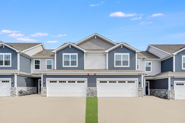 view of property with a garage, driveway, and board and batten siding