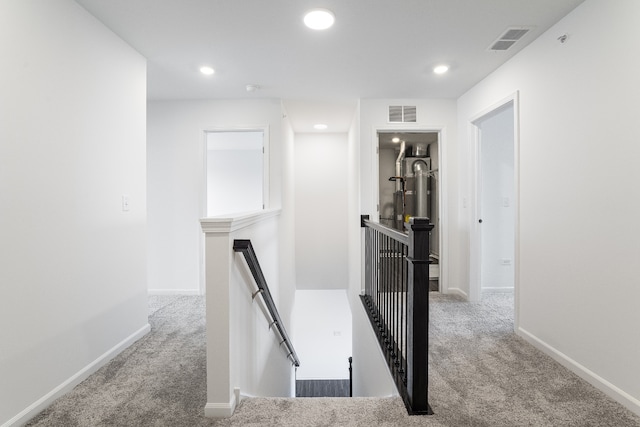 hall featuring visible vents, carpet, an upstairs landing, and recessed lighting