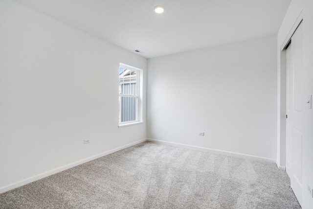 unfurnished room featuring recessed lighting, visible vents, baseboards, and light colored carpet