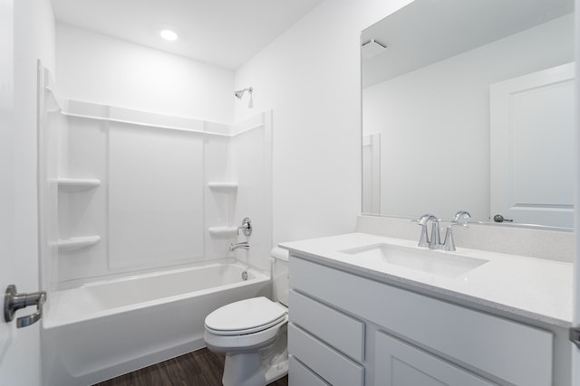 full bathroom featuring toilet,  shower combination, wood finished floors, and vanity