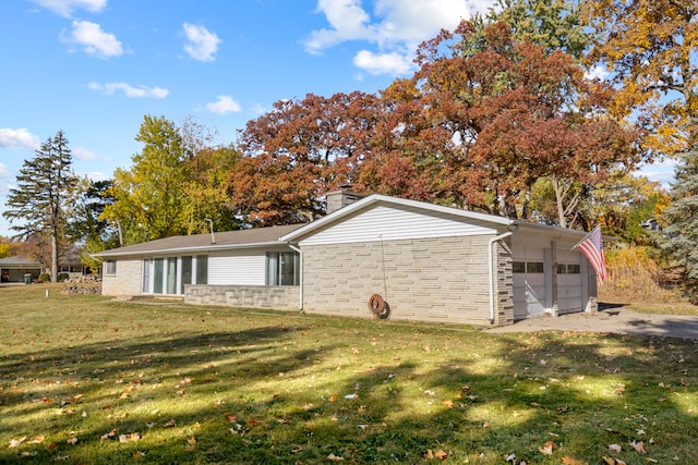 view of side of home featuring a yard and a garage