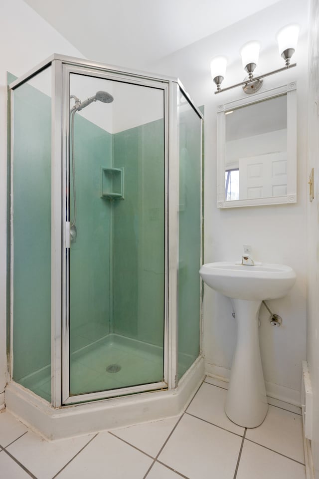 bathroom featuring walk in shower and tile patterned flooring